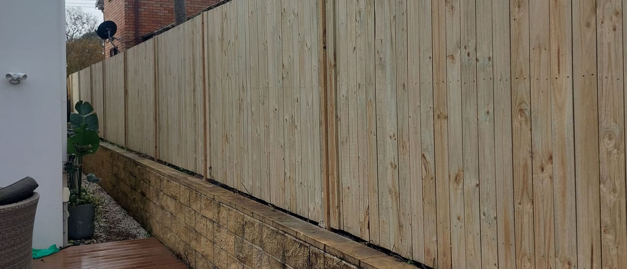 Tall treated pine timber privacy fence built along a rear boundary at a Sydney property